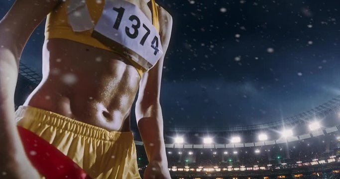 Track and field female  runner crosses finishing line