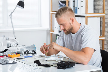 Technician Repairing Quadrocopter Drone