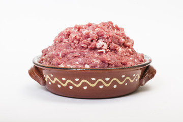 Minced meat in ceramic bowl isolated on white background