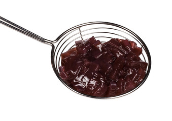 brown topping for ice cream in spoon isolated on white background