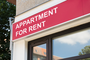 Apartment for rent sign on modern building in city