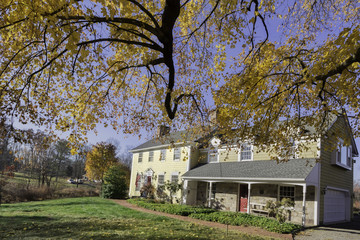 Fototapeta na wymiar Beautiful remodeled late 1800's house contrasting colors of fall.