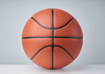 Basketball ball close up image on light grey background.