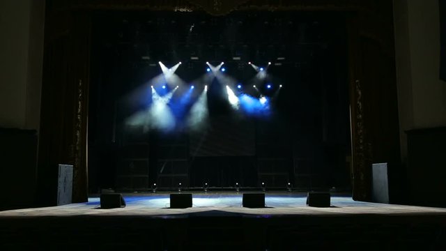 Flashing concert light in an empty theater. Free stage with lights. Stage lights.