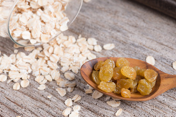 Dry rolled oat flakes oatmeal on old wood table