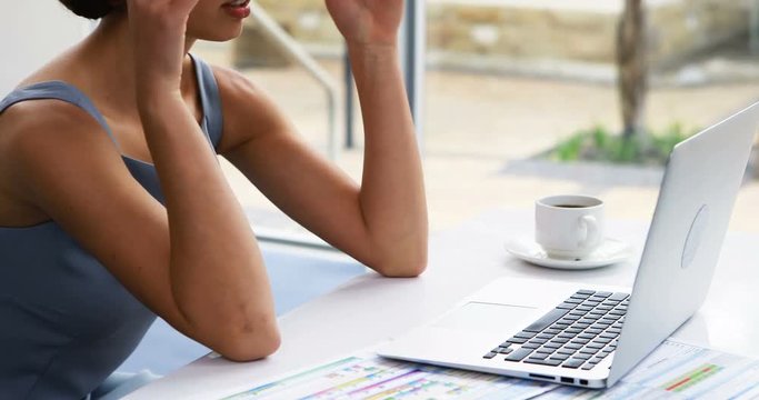 Thoughtful female business executive sitting at desk 