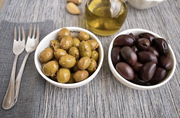 Pickled olives green and black with olive oil.