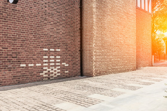 Fototapeta Red brick wall and empty floor sidewalk
