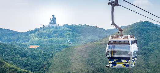 Obraz premium Tian Tan Buddha statue and cable car. Located at Ngong Ping, Lantau Island, in Hong Kong.
