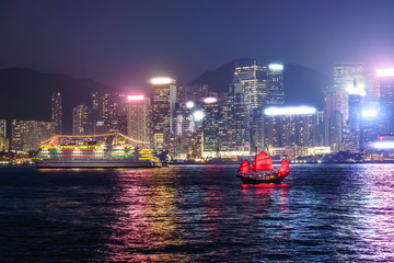 Fototapeta premium Sailing the antique boat DUKLING in Hong Kong. Enjoy skyscrapers and cityscape view across Victoria Harbour on an authentic Chinese junk.