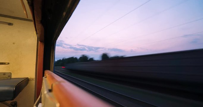 Night Timelapse, The Train Is Traveling By Rail, View From The Train Window, Nature Outside The Window, Blurred Lights.
