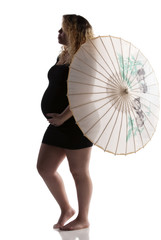 pregnant mother in black dress and umbrella does a fashion pose in studio