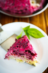 layered pastry salad with herring and beetroot