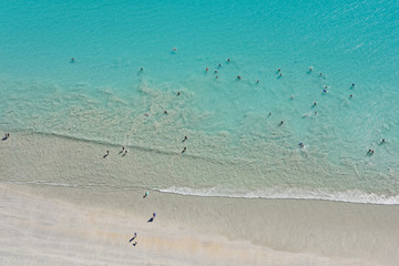 Looking down upon people enjoying the wide sands and waters of Cable Beach