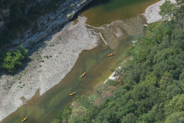     Vallon-Pont-d'Arc in Ardeche, gorges, beautiful touristic landscape with kayaks on the river in France
