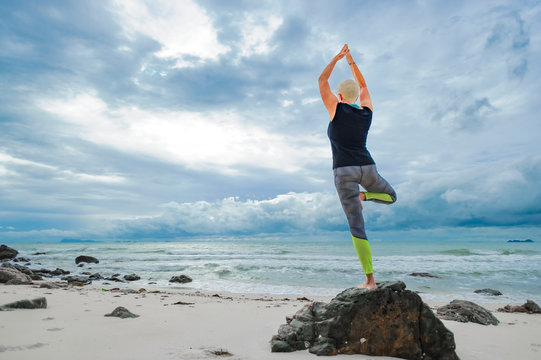 A Woman Practicing A Yoga Pose Standing On One Leg And Arms Lifted Up Stock  Photo, Picture and Royalty Free Image. Image 24691065.
