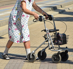 Old woman walks with a walker