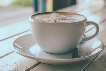 Cup of coffee on the wooden table, Soft focus, Vintage tone