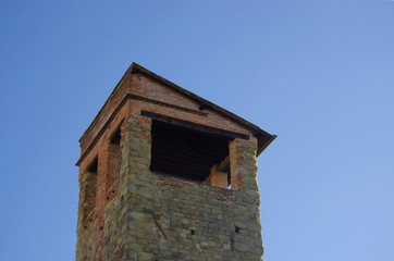 Fototapeta na wymiar Ancient Italian stone tower and brick