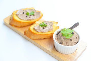 Chicken liver pate with bread on a wooden table. Top view