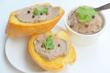 Chicken liver pate with bread on a wooden table. Top view