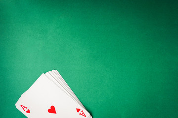 Playing cards on green background. Free space for text