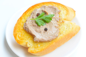Chicken liver pate with bread on a wooden table. Top view