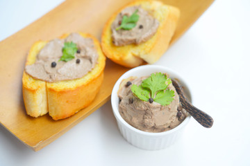 Chicken liver pate with bread on a wooden table. Top view