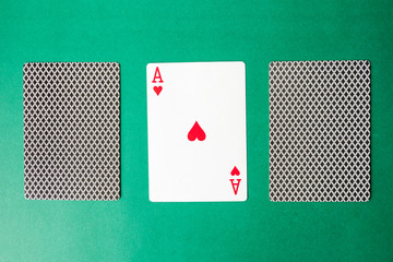 Playing card and back designs on green background. Free space for text
