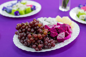 delicious  fruit , grapes, dragon fruit , melon  on the white bowl , healthy food for everybody with copy space
