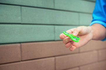 Teenager hand holding relaxing gadget fidget spinner