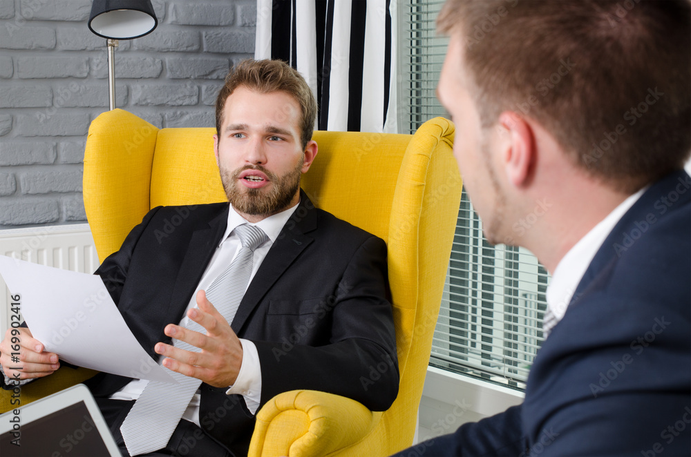 Wall mural two business people talking in a modern office