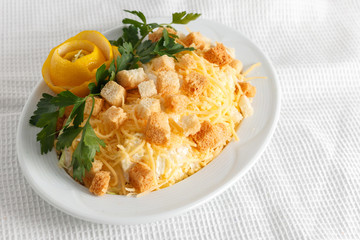 cesar salad with greens on a white plate