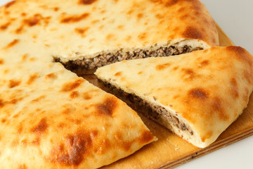 round pie with filling on a table