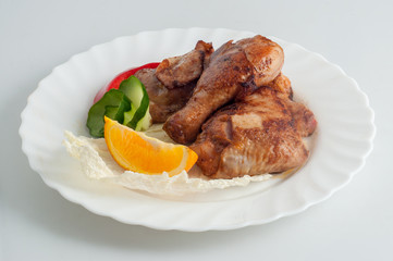 Chicken barbecue kebab on skewer on a white plate