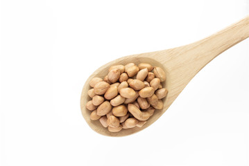 Raw peanut with wooden spoon on white background.
