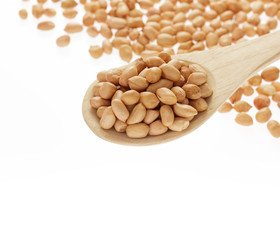 Raw peanut with wooden spoon and pile of peanut  on white background.