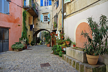 Narrow street with flowers in the old town Coaraze in France