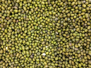 Background pattern texture of mung bean (green bean) seeds for concept of healthy lifestyle diet / organic nutrition or whole grain food