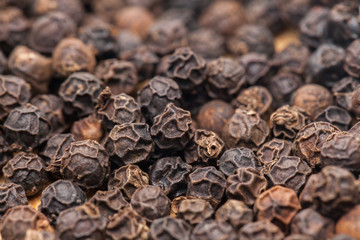 pile of Black Pepper on wooden plate