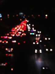 Abstract bokeh lights from moving cars at night, lens blur applied, for concept of traffic jam at night in a city. For use as background or wallpaper