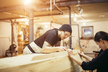 carpenter man in workshop glue wood work for construction