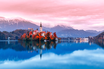 Bled lake in Slovenia, famous and very popular landmark and travel destination. Night scene of island with ancient church in the middle of Bled lake. Romantic place, sunset dusk scenery. Fall season.