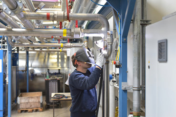Schweißer repariert Rohrleitungen einer Industrieanlage // Welder repairs pipelines of an industrial plant