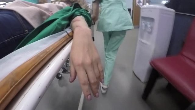 Medics pull the stretchers with sick patient