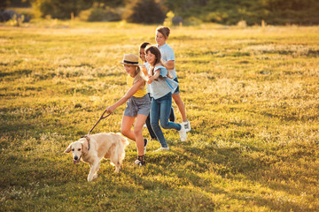Fototapeta premium teenagers with dog in park