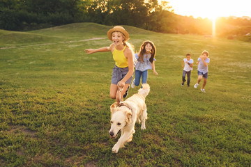 teenagers with dog walking in park