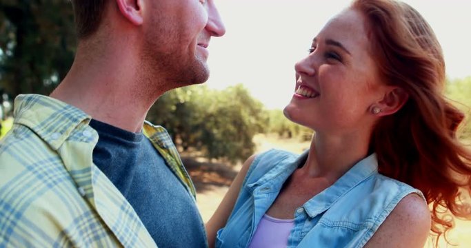 Happy couple interacting with each other in olive farm 