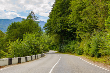 Obraz premium Curved asphalt road in mountains