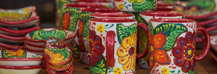 Fototapeta na wymiar Pottery cups, bug, jugs at market in Barcelona
